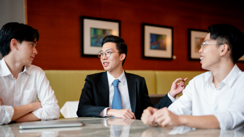 a person with formal attire talking to his friends